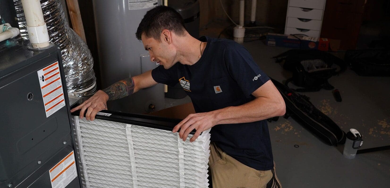tech replacing air filter in furnace