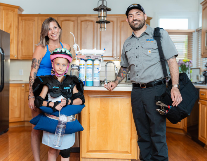 A Five Star Home Services technician visits an Ohio family’s home to install a hard water solution, showcasing clean, filtered water from a reverse osmosis system in the kitchen.