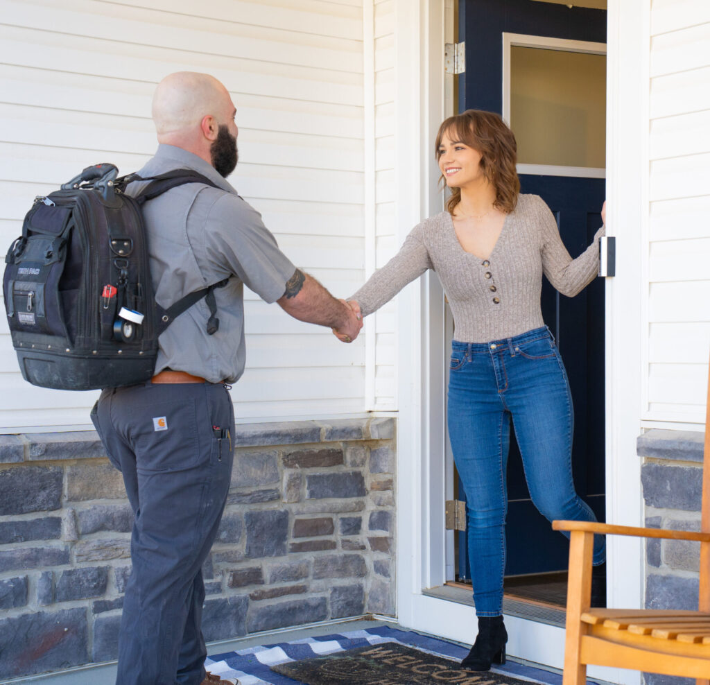 Furnace Repair Tech Ben Reed furnace repair technician greeting homeowner