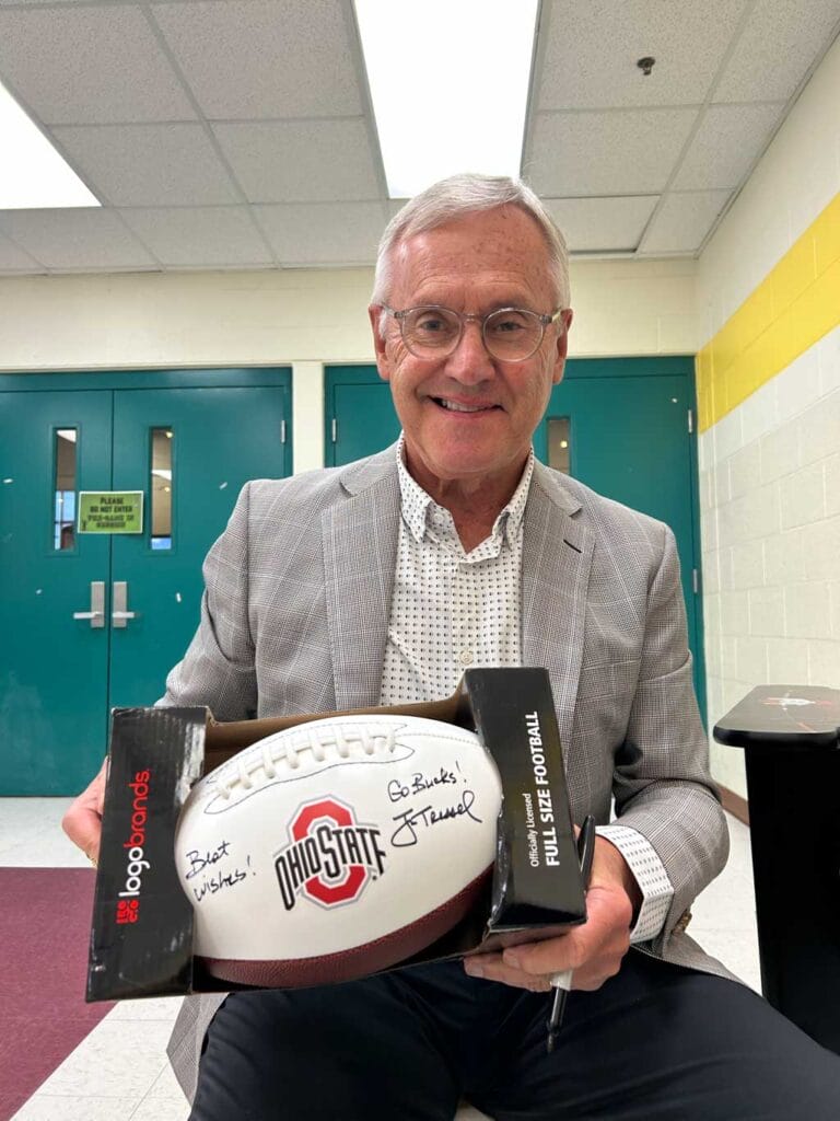 Jim Tressel holding autographed football
