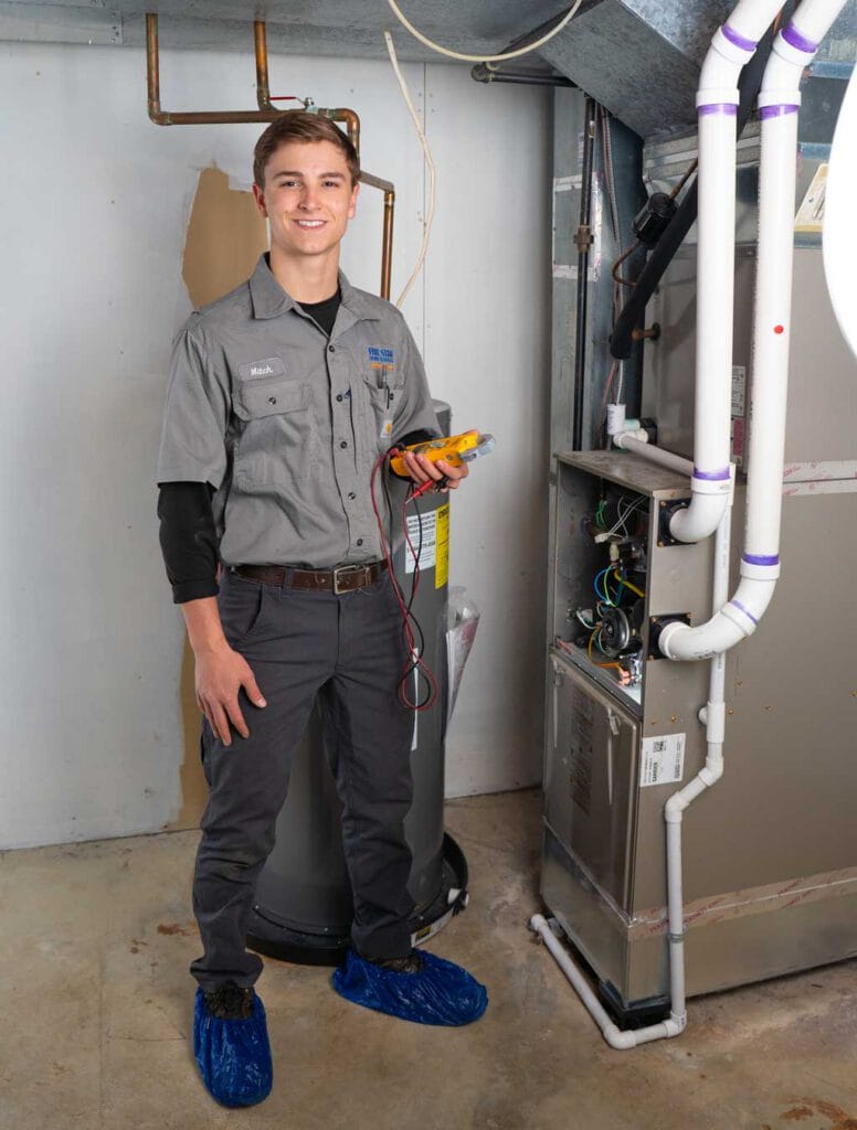 HVAC Tech next to furnace