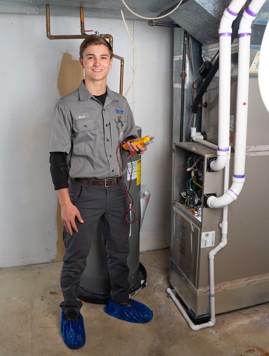 HVAC Tech next to furnace