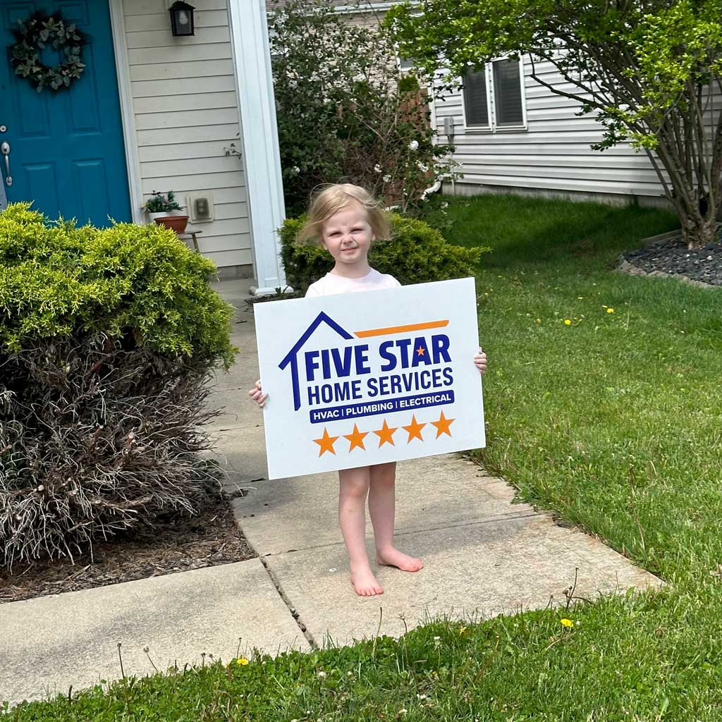 kid holding five star lawn sign