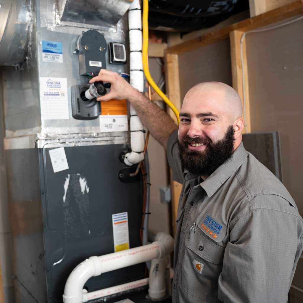 Furnace Repair | Five Star Home Services technician repairing furnace