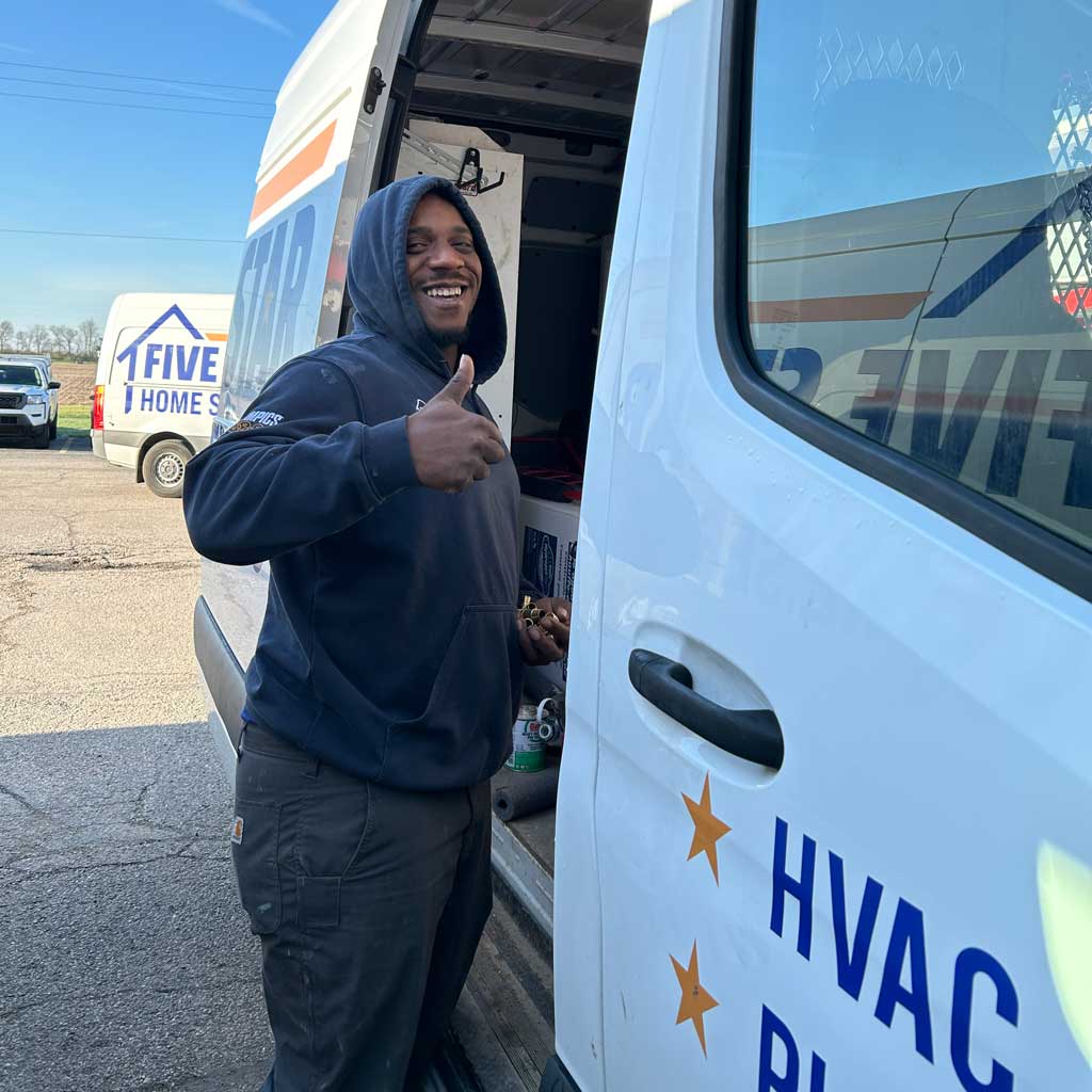 tech smiling with thumbs up