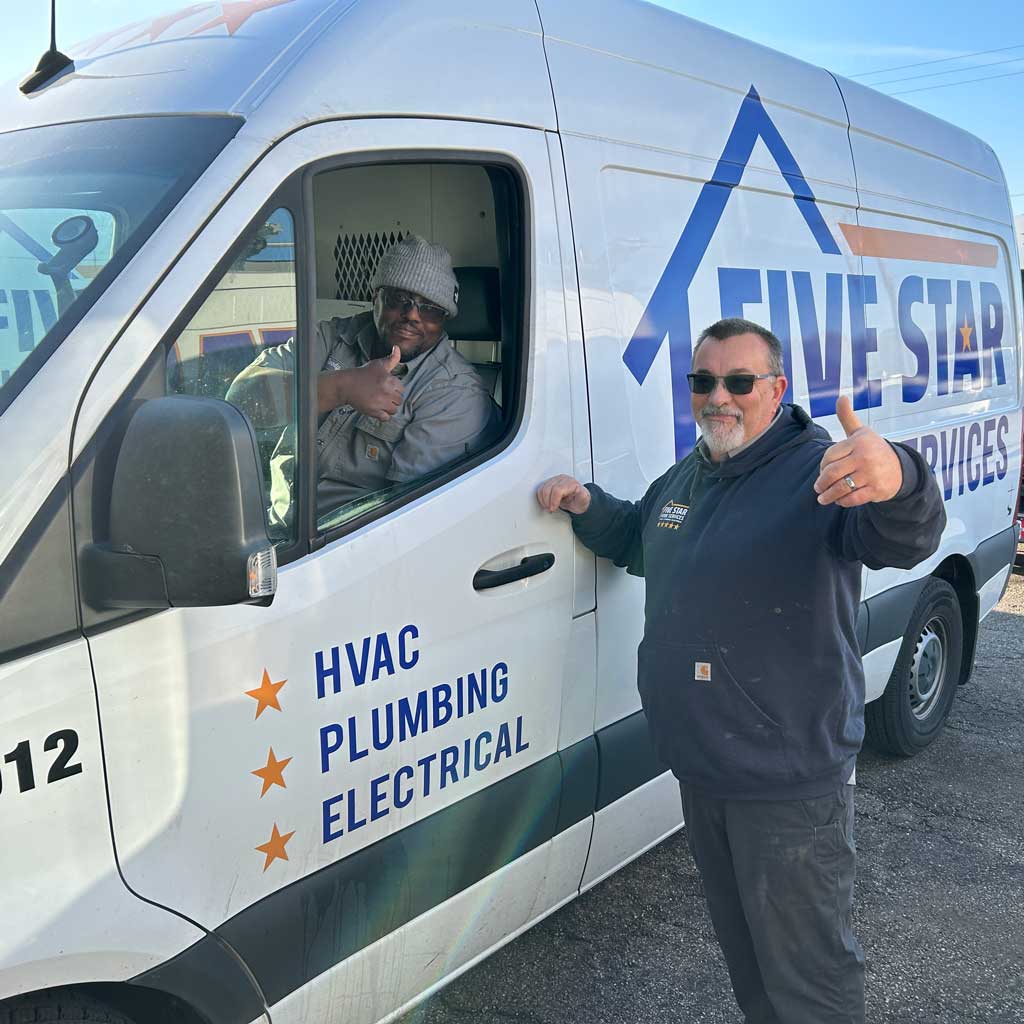 tech smiling with thumbs up